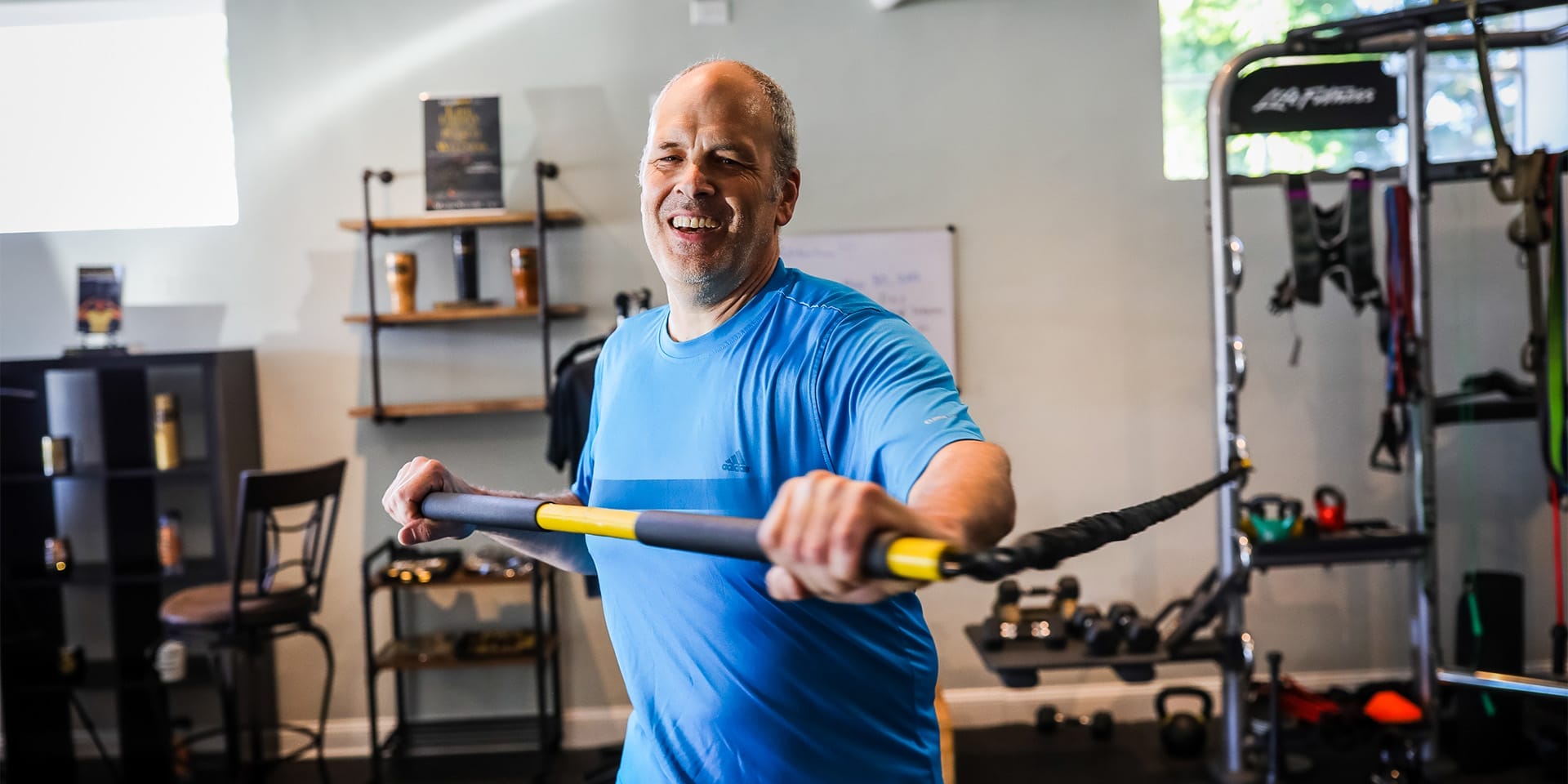 man smiling and working out at Safe Haven Fitness